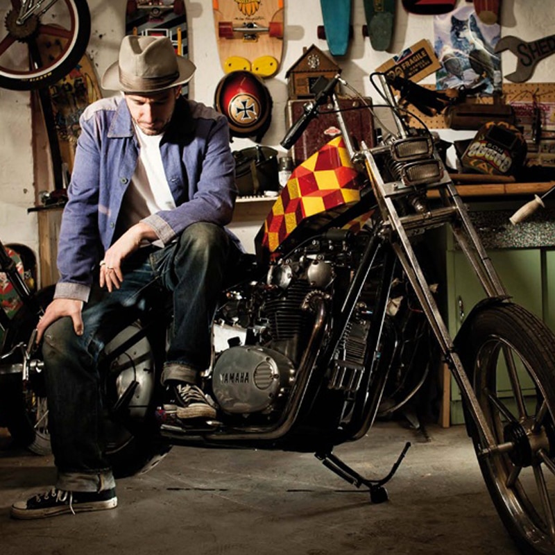 Man sitting on a motorbike in a workshop