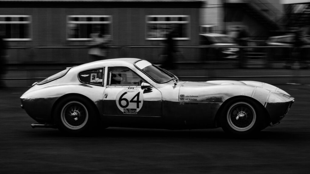 Black and white picture of car racing
