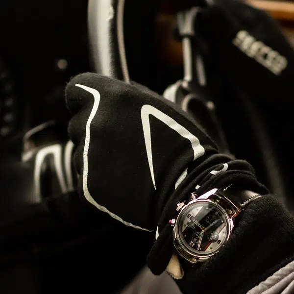 CR2 watch on leather strap worn on wrist with racing gloves