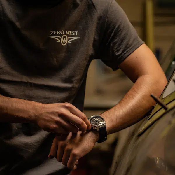 Man wearing zero west t-shirt and winding watch