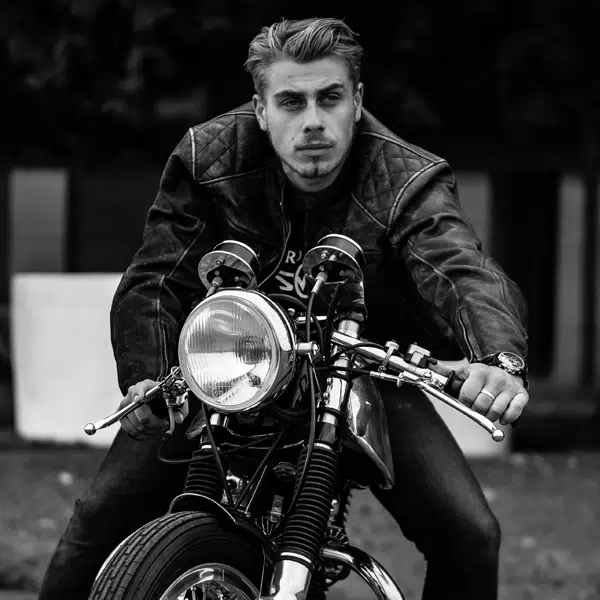 Black and white picture of man on motorbike