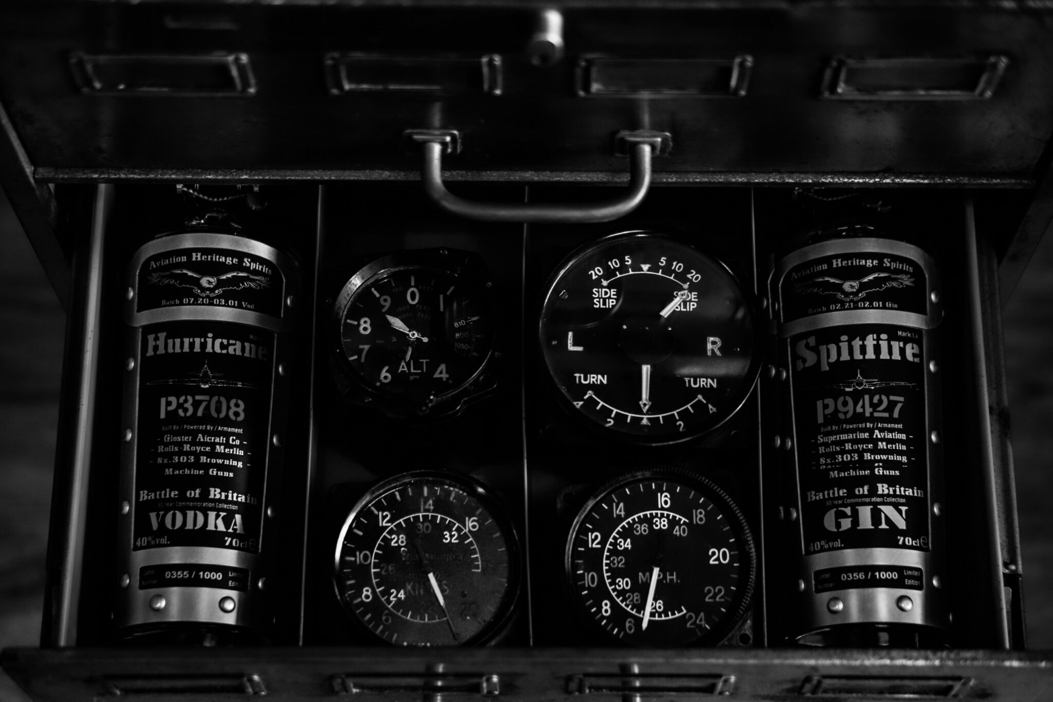 Bottle of Hurricane vodka and bottle of Spitfire gin alongside aircraft dials
