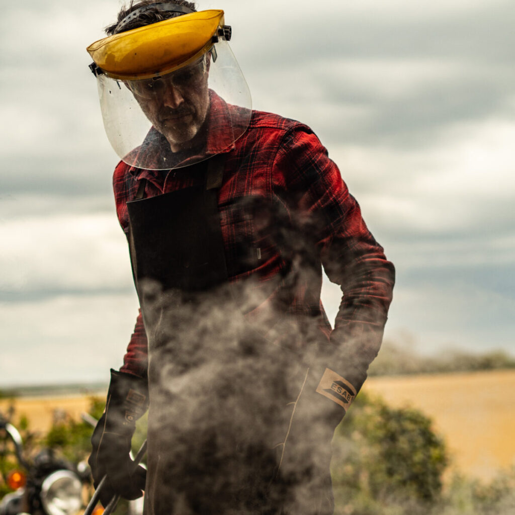 Man wearing a visor with smoke rising