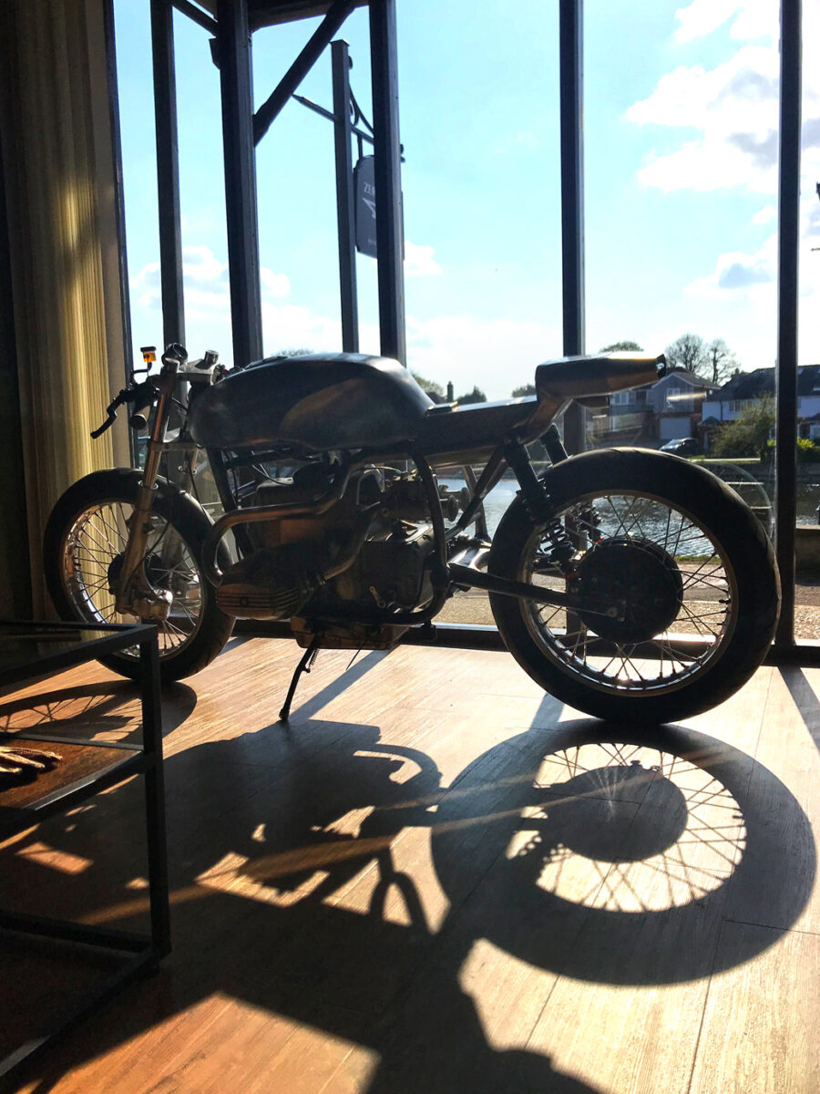 Motorbike photographed from inside the studio looking out of the window