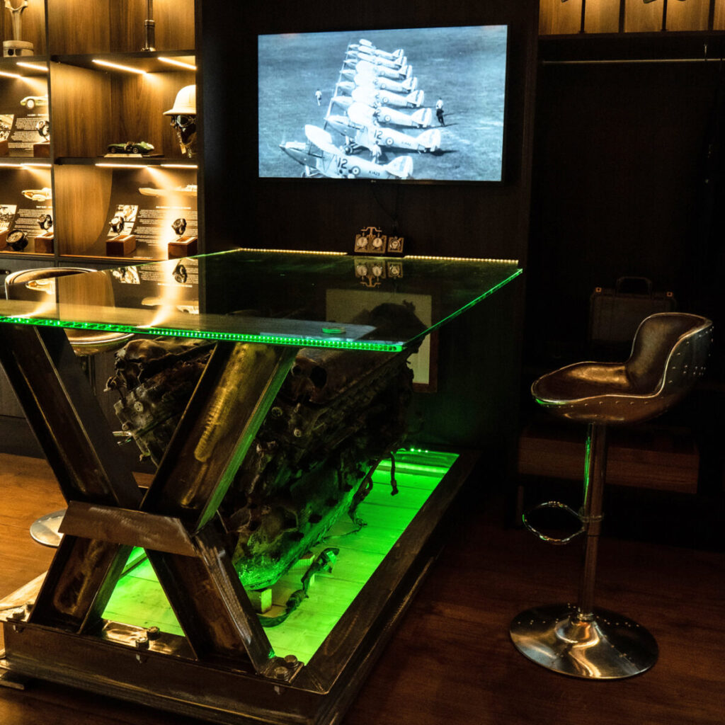 Inside studio spitfire engine in table with television in background