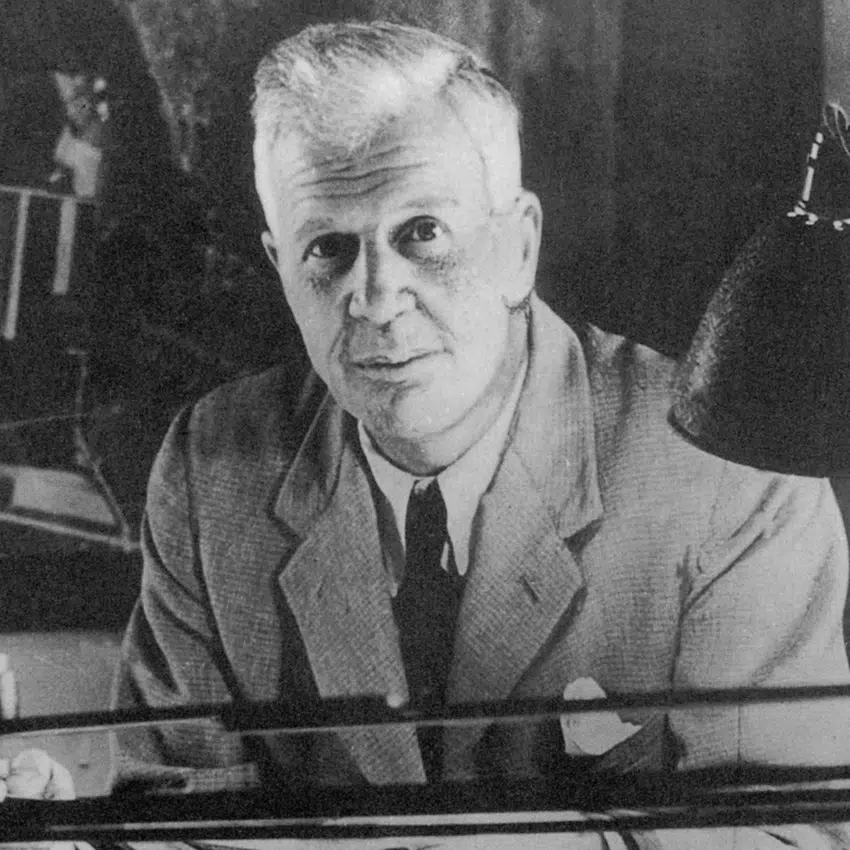 Sir Barns Wallis sitting at a desk