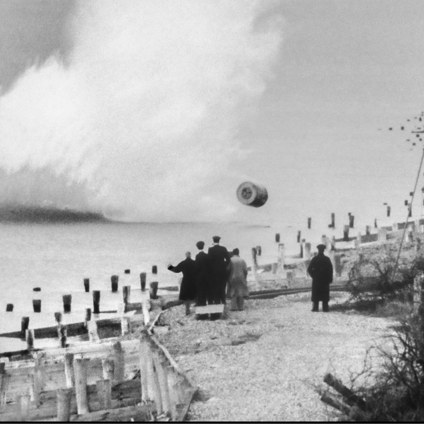 Dambuster bouncing bomb test with several people watching