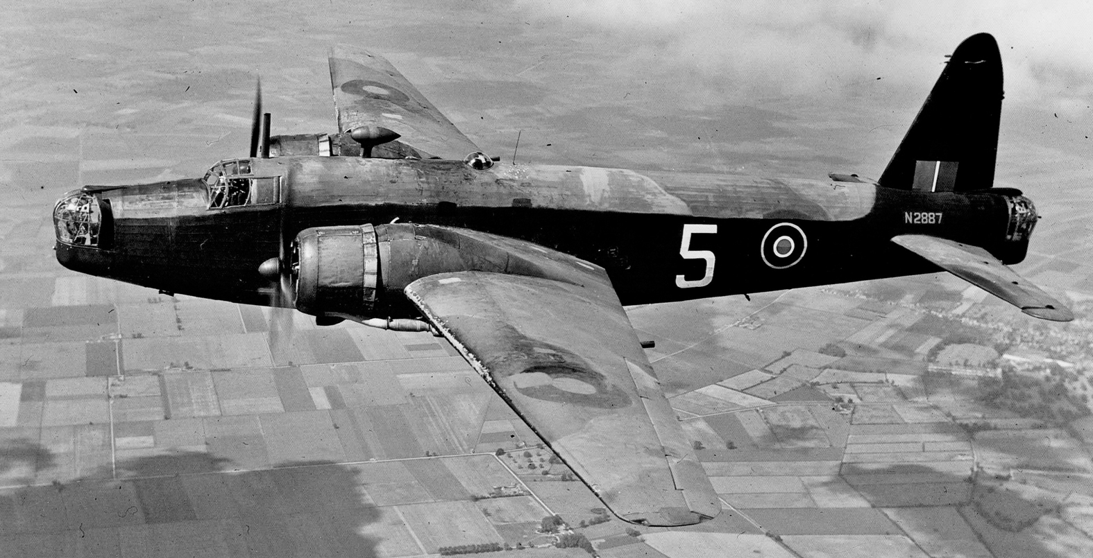 Wellington Bomber flying over English countryside