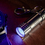Zero West UV mini torch next to watch