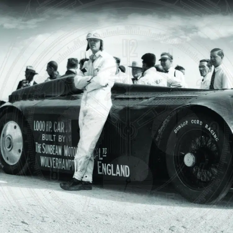 Black and white photo of Sunbeam car and men standing beside