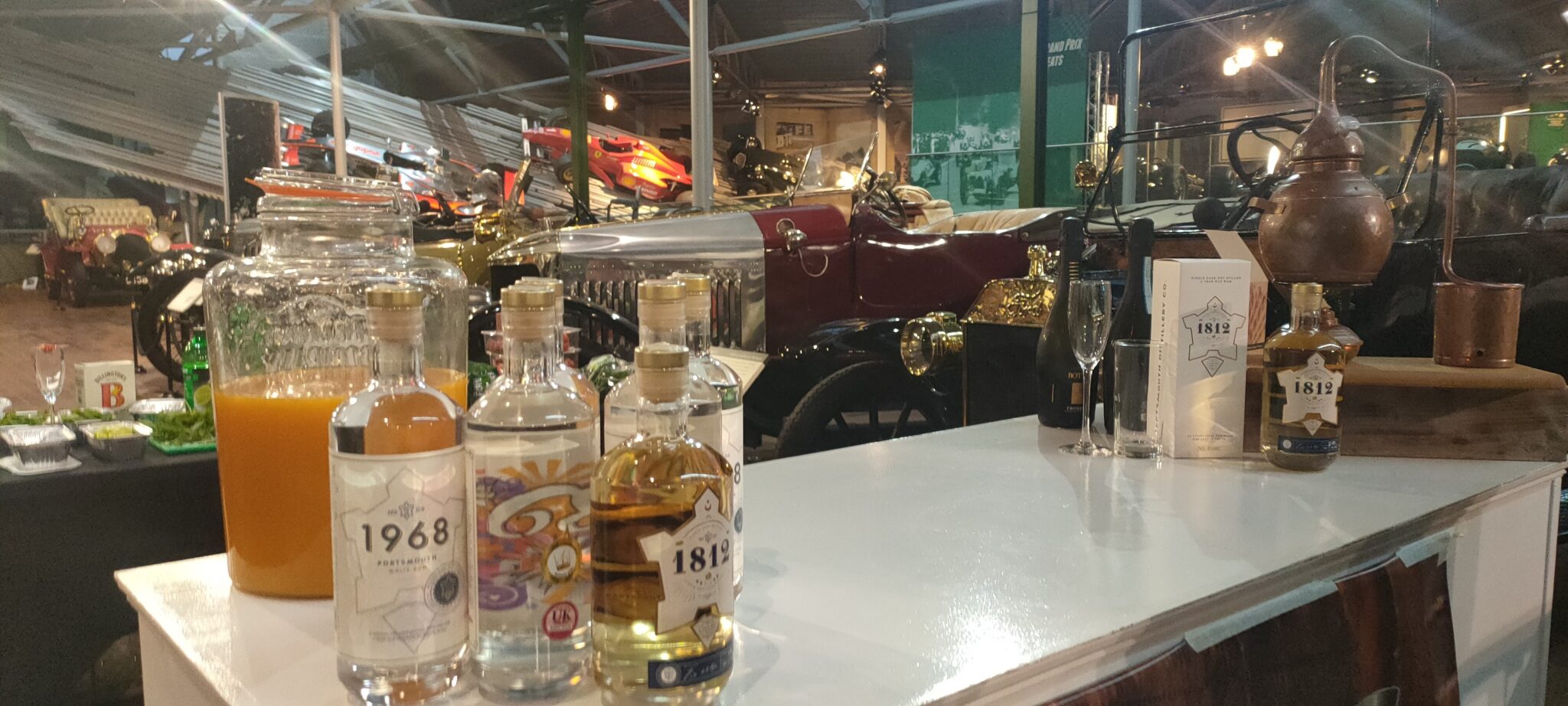 Selection of alcohol bottles on a bar with car in the background