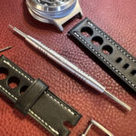 Spring bar tool next to leather strap