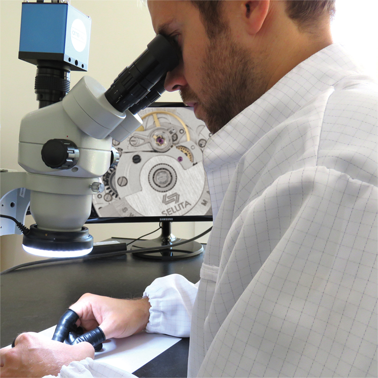 man checking watch through microscope