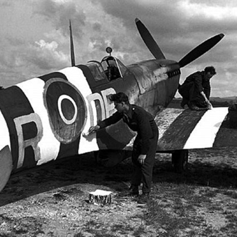 Men painting invasion stripes on Spitfire