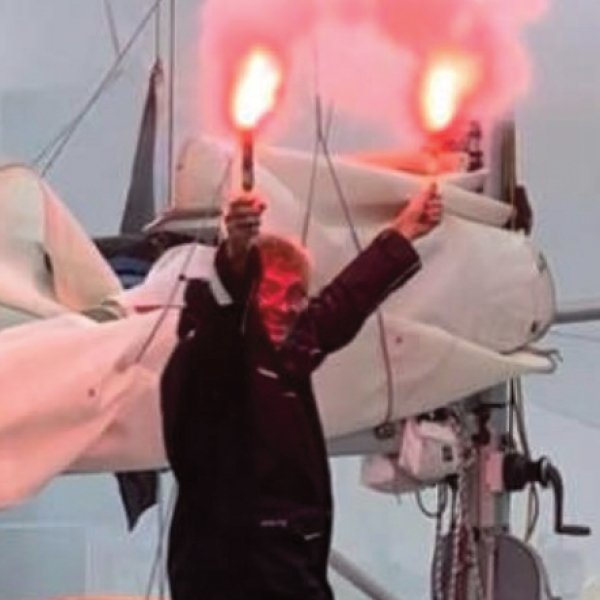 Man holding flares on boat