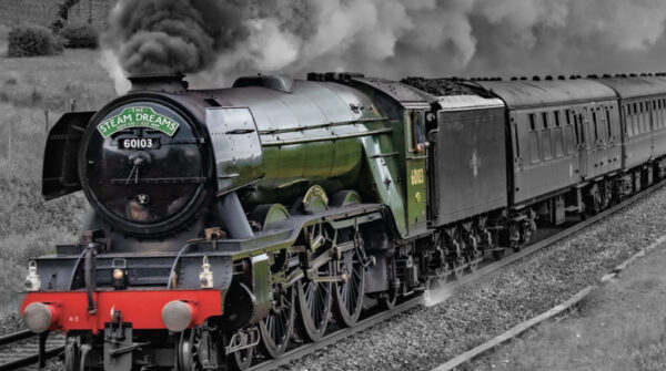 Classic steam train on railway tracks