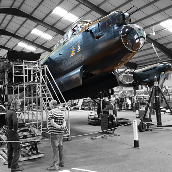 Men discussing a vintage aircraft restoration
